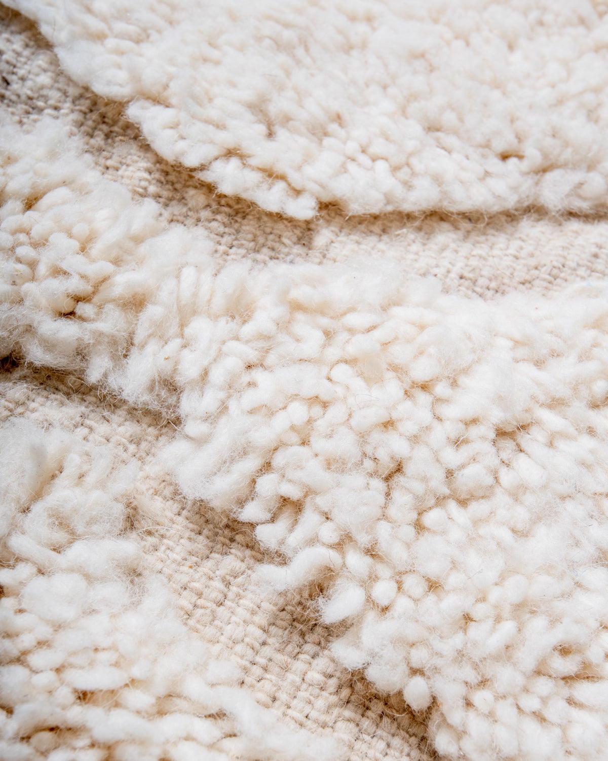 Modern, designer, handcrafted Berber rug from Morocco. Beniourain carpet with minimalist design, natural wool pile and a fluffy texture.